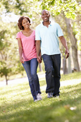 Fototapeta premium Young couple walking in park