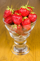 Strawberries in glass on wooden table