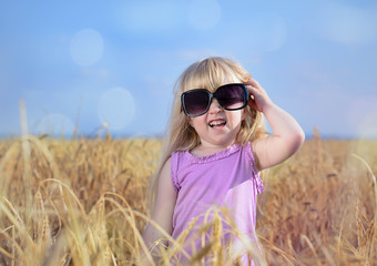 Adorable little blond girl in huge sunglasses