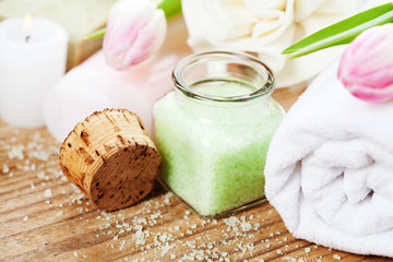 Spa setting with bath accessories and pink tulips