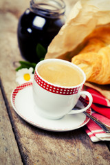 Breakfast setting: cup of coffee and croissants