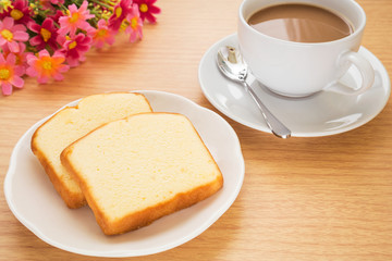 Obraz na płótnie Canvas Butter cake sliced on plate and coffee cup