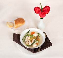 Mushroom soup, bread slices and tulips