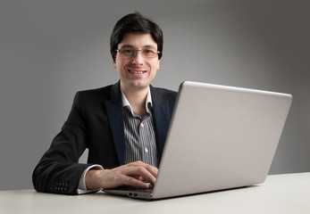 Busy businessman in office working on his laptop