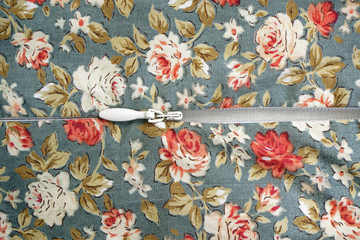Closeup of zipper on flower pattern fabric