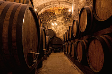 Wooden barrels with wine in a wine vault, Italy © Shchipkova Elena