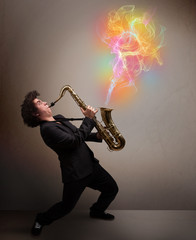 Attractive musician playing on saxophone with colorful abstract