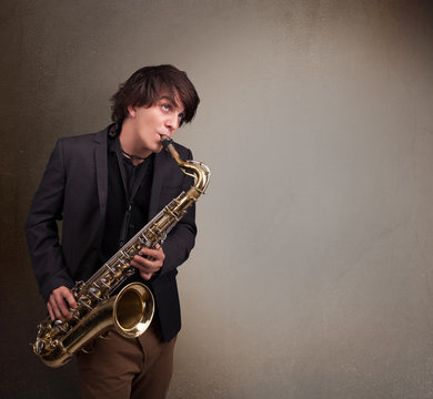 Young musician playing on saxophone