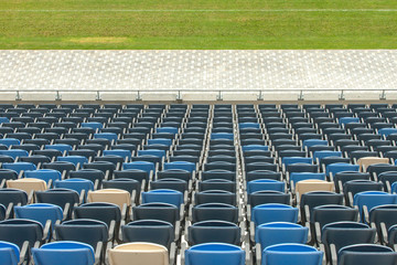 Naklejka premium Stadium seats and green grass