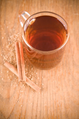 black tea in glass with cinnamon and cane sugar