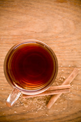 black tea in glass with cinnamon and cane sugar