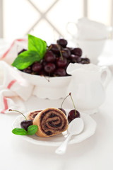Cake roll with cherry jam, selective focus