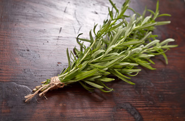 Bunch of rosemary on a rustic wood 
