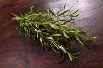 Bunch of rosemary on a rustic wood 
