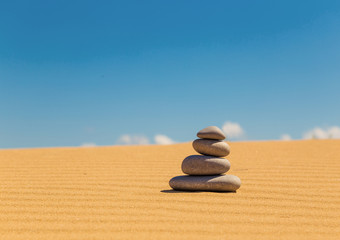 Fototapeta na wymiar Zen stones on the sandy dune