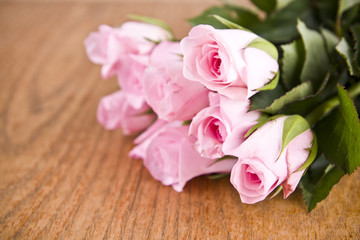 pink roses on wooden background