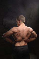 Fototapeta premium Athletic man on black backgrounds