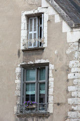 Fototapeta na wymiar Two windows with shutters and flower pot