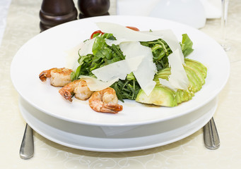shrimp salad and greens on a white background