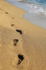 Sandy shoreline with footprints Falasarna Crete