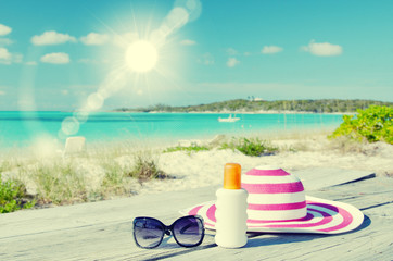 Sun lotion, sunglasses and hat