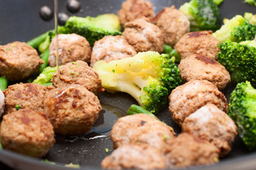Meatballs, broccoli and spinach stir-fried