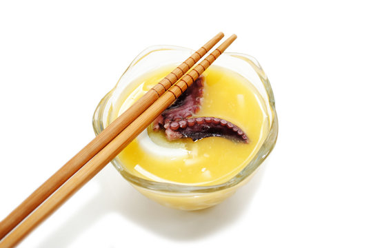 Tentacle Soup Served in a Glass Bowl with Chopsticks