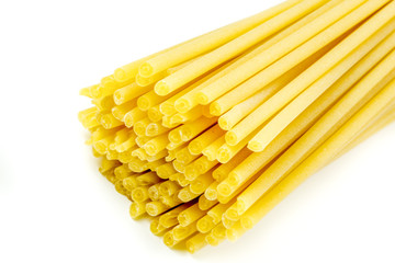 Uncooked Italian spaghetti on a white background