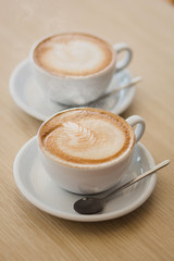 Two cups of cappuccino on the table