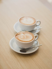 Two cups of cappuccino on the table