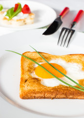 Flower shaped fried egg in toast for breakfast or snack.