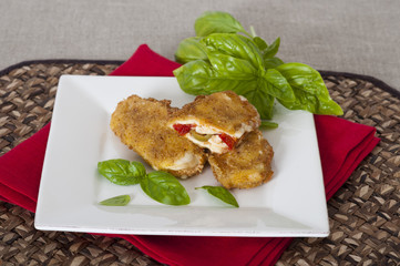 Breaded mozzarella with peppers, olives and basil
