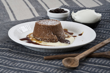 Chocolate flan with cream and ice-cream