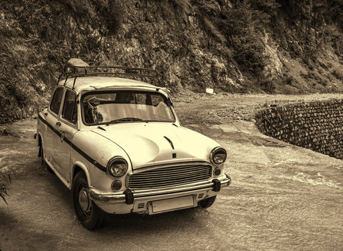 Vintage style photo of retro car parked at nature