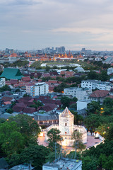 Ancient fortress tower with Grand Palace at Dusk