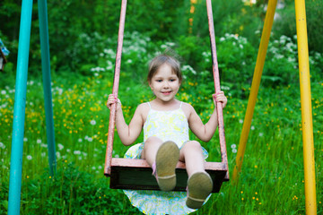Little beautiful girl swinging in park - 66839519