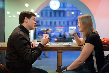 Man and woman chatting over coffee
