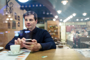 Man at the table texting
