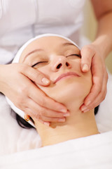 Fototapeta na wymiar Woman in the beauty spa getting a facial massage