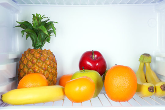 Fruits in open refrigerator. Weight loss diet concept.