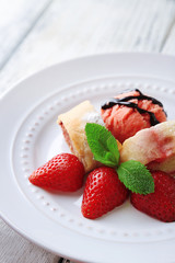 Tasty homemade strudel with ice-cream, fresh strawberry and