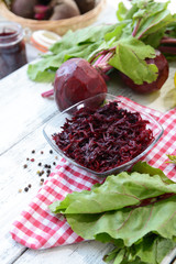 Grated beetroots in bowl on table close-up