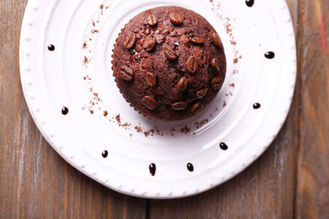 Chocolate muffin on plate wooden background