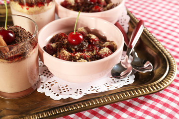 Tasty cherry dessert on table