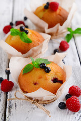 Tasty cupcakes with fruits on table close-up