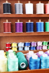 Colorful threads for needlework in wooden box close up