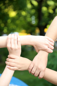 Hands in group on natural background