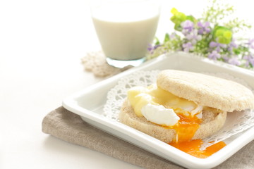 Fototapeta na wymiar poached egg and cheese in English muffin Sandwish