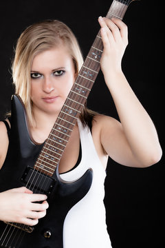 Rock music. Girl musician playing on electric guitar