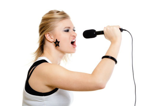 girl singer singing to microphone isolated on white.